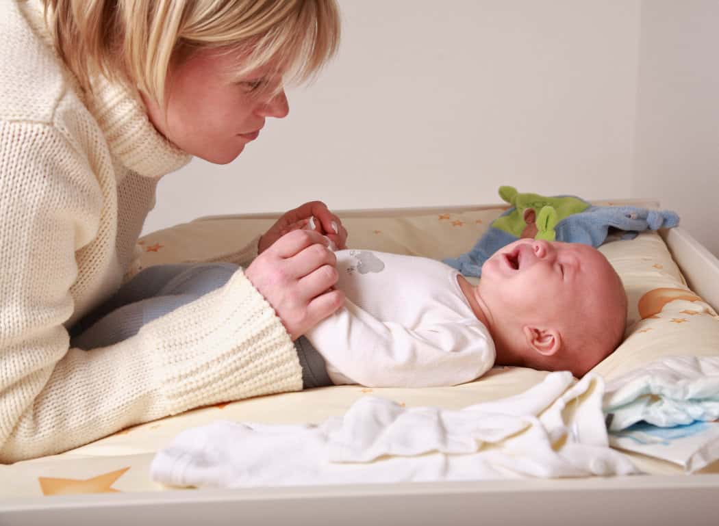 Mom feels bad after clipping baby's finger while trimming baby’s nail